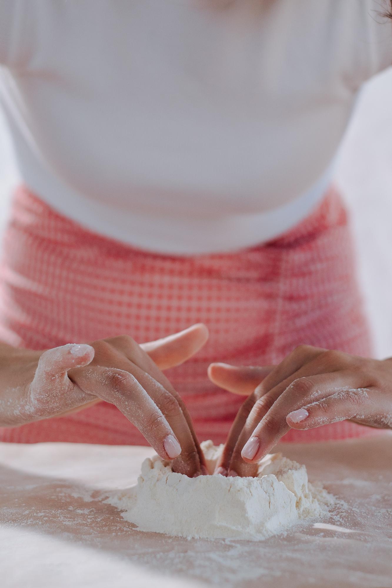 close-up of hands kneading dough